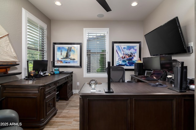 office space featuring ceiling fan, light hardwood / wood-style floors, and a healthy amount of sunlight