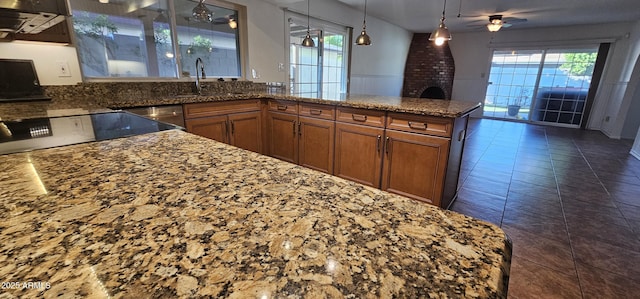 kitchen featuring dishwasher, a healthy amount of sunlight, ceiling fan, and decorative light fixtures