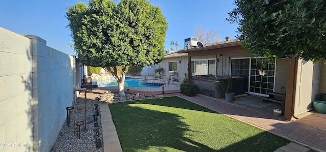 view of yard featuring a fenced in pool and a patio area