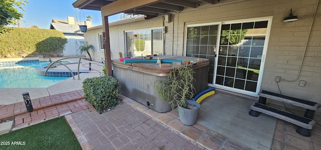 view of patio with a swimming pool with hot tub