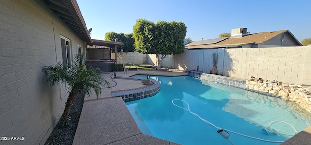 view of pool featuring a hot tub and a patio area