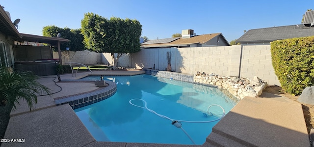 view of pool with a hot tub and central air condition unit