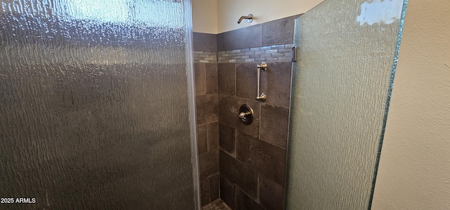 bathroom with a tile shower