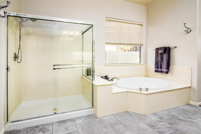 bathroom with tile patterned flooring and separate shower and tub