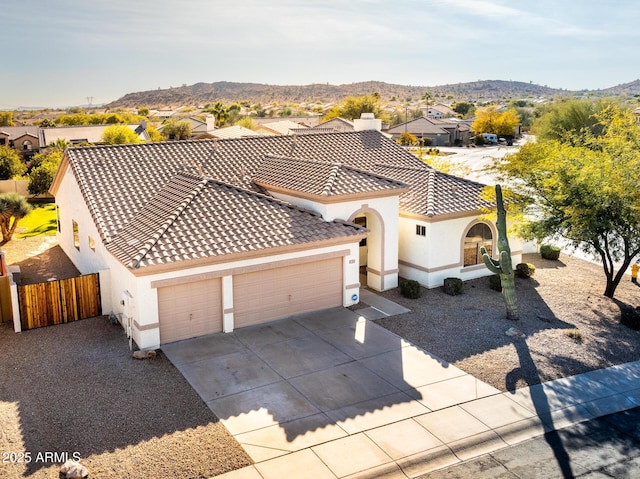 view of front of house with a garage and a mountain view