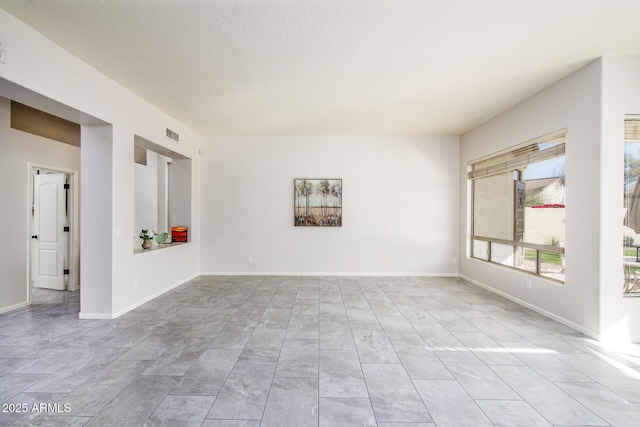 empty room featuring visible vents and baseboards