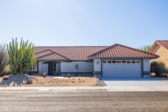 mediterranean / spanish home with a garage