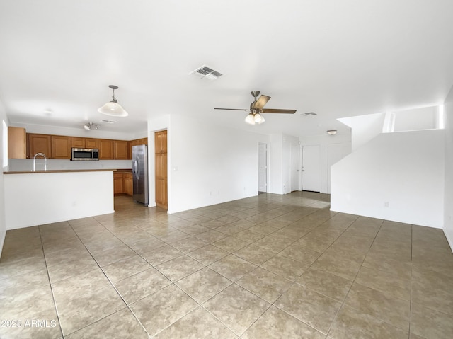 1078 E Poncho Ln, San Tan Valley, AZ 85143 - unfurnished living room featuring light tile patterned floors, a ceiling fan, and a sink