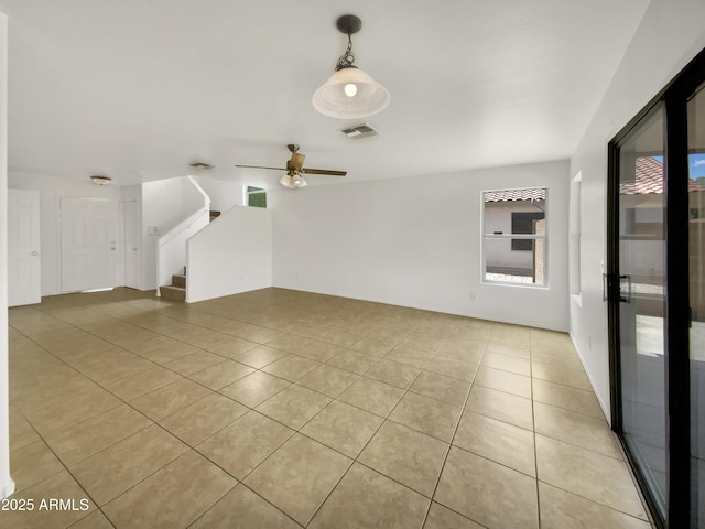 1078 E Poncho Ln, San Tan Valley, AZ 85143 - unfurnished living room featuring stairs, light tile patterned floors, and a ceiling fan