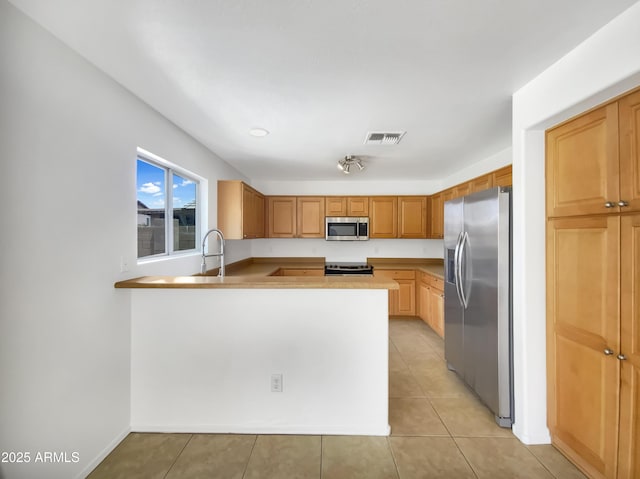 1078 E Poncho Ln, San Tan Valley, AZ 85143 - kitchen featuring stainless steel appliances, a peninsula, a sink, light tile patterned floors, and light countertops