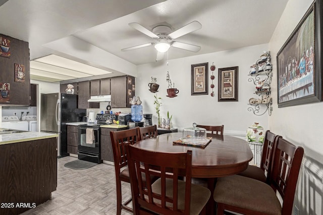 dining area with washer and dryer, ceiling fan, and light parquet floors