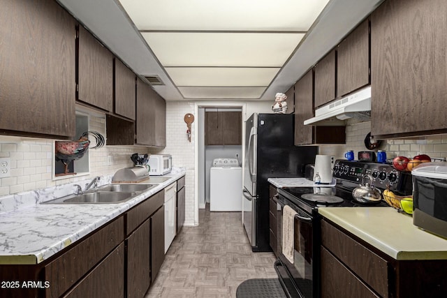 kitchen with sink, white appliances, washer / dryer, dark brown cabinets, and light parquet flooring