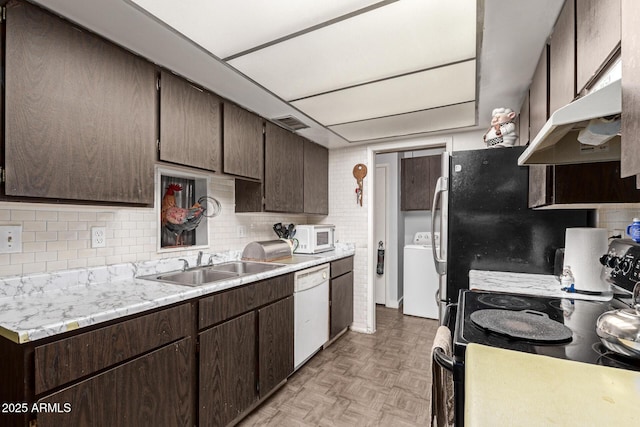 kitchen featuring white appliances, sink, washer / dryer, dark brown cabinetry, and light parquet flooring