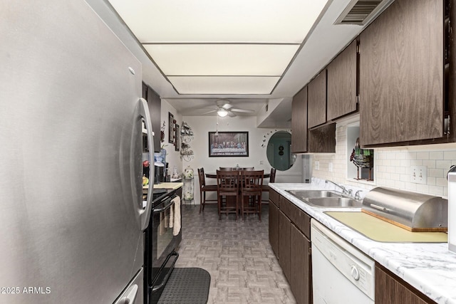 kitchen featuring stainless steel refrigerator, ceiling fan, sink, black range with electric cooktop, and white dishwasher