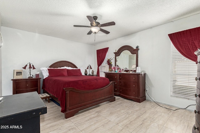 bedroom featuring ceiling fan and a textured ceiling