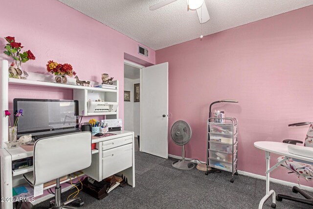 carpeted office space featuring a textured ceiling and ceiling fan