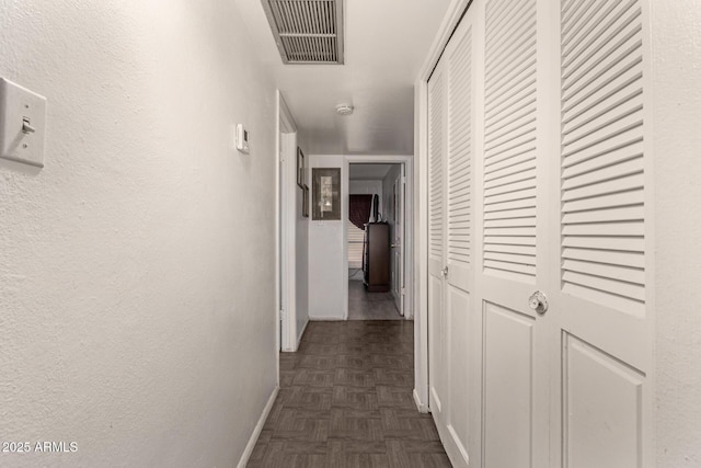 hallway with dark parquet flooring