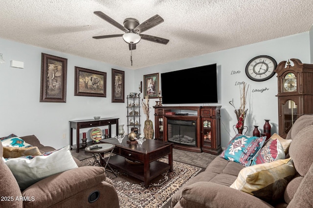 living room featuring ceiling fan and a textured ceiling