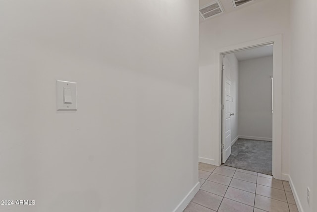 corridor featuring light tile patterned floors