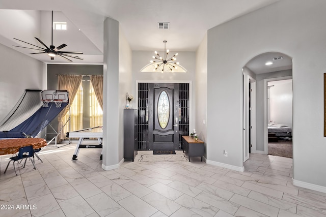 foyer featuring baseboards, visible vents, marble finish floor, and arched walkways