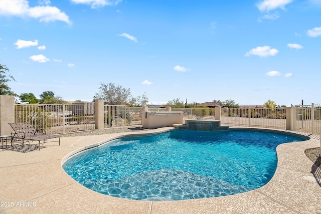 view of swimming pool featuring fence, exterior kitchen, a fenced in pool, and a patio area