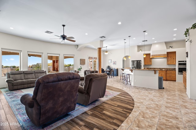 living area featuring a healthy amount of sunlight, visible vents, ceiling fan, and recessed lighting