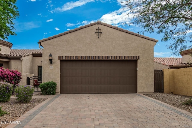 1813 N Trowbridge, Mesa, AZ 85207 - pueblo-style house with a garage, a tiled roof, a gate, and stucco siding