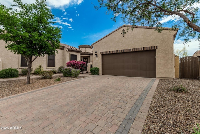 1813 N Trowbridge, Mesa, AZ 85207 - mediterranean / spanish-style house with a gate, decorative driveway, a tiled roof, an attached garage, and stucco siding