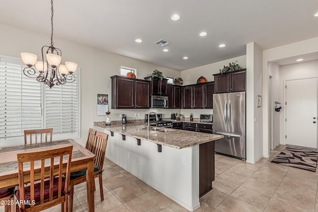 1813 N Trowbridge, Mesa, AZ 85207 - kitchen featuring a sink, dark brown cabinetry, a peninsula, appliances with stainless steel finishes, and visible vents