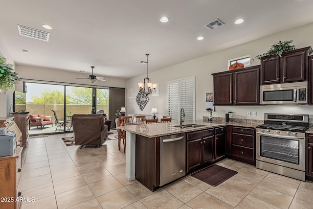 1813 N Trowbridge, Mesa, AZ 85207 - kitchen featuring a sink, ceiling fan with notable chandelier, open floor plan, dark brown cabinetry, and stainless steel appliances