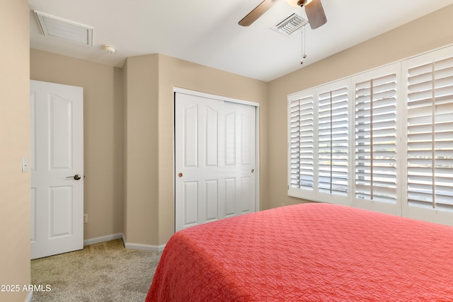 carpeted bedroom with baseboards, ceiling fan, a closet, and visible vents