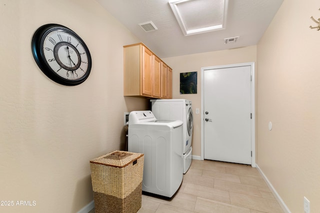 clothes washing area featuring independent washer and dryer, baseboards, visible vents, and cabinet space