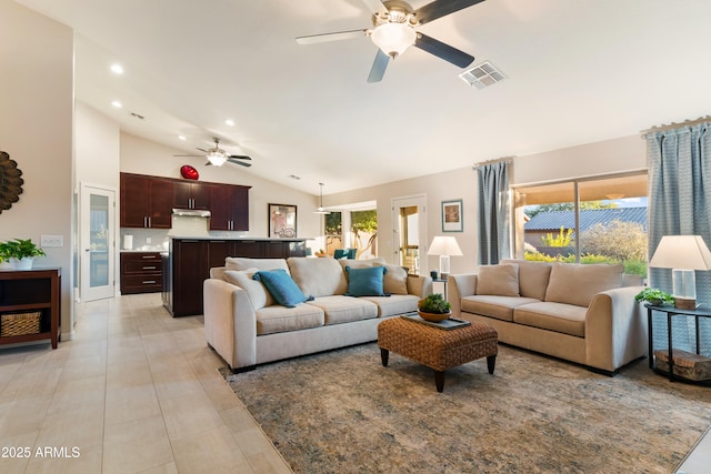 living room featuring a ceiling fan, visible vents, a healthy amount of sunlight, and lofted ceiling