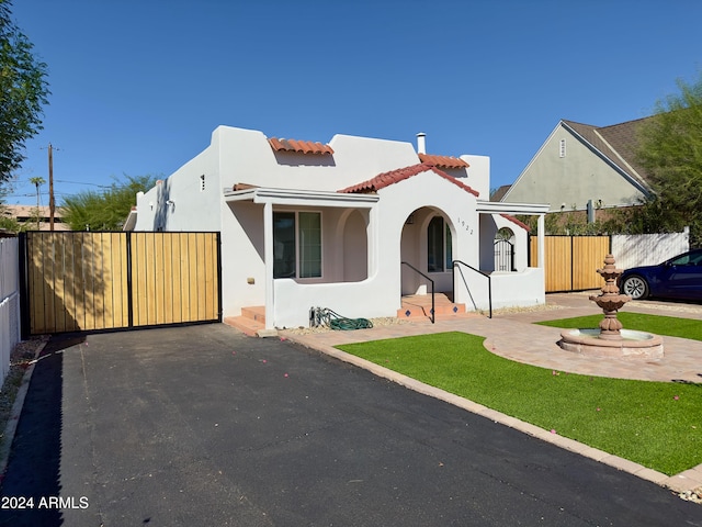 mediterranean / spanish house with a front yard