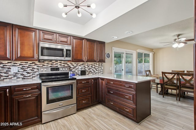 kitchen with decorative backsplash, appliances with stainless steel finishes, and light countertops