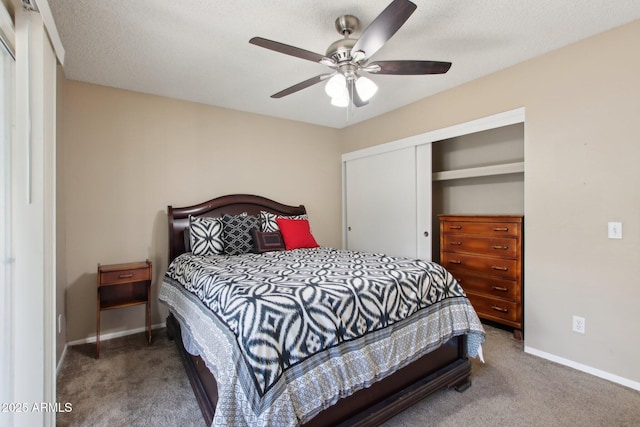 carpeted bedroom with a closet, baseboards, a textured ceiling, and a ceiling fan