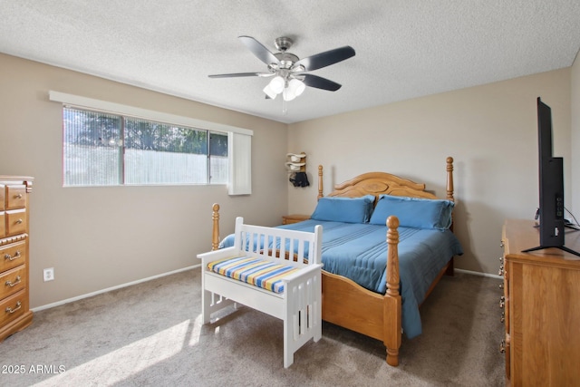 bedroom with ceiling fan, baseboards, carpet floors, and a textured ceiling