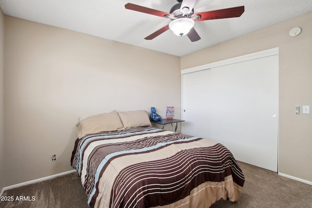 bedroom featuring a closet, carpet floors, baseboards, and ceiling fan