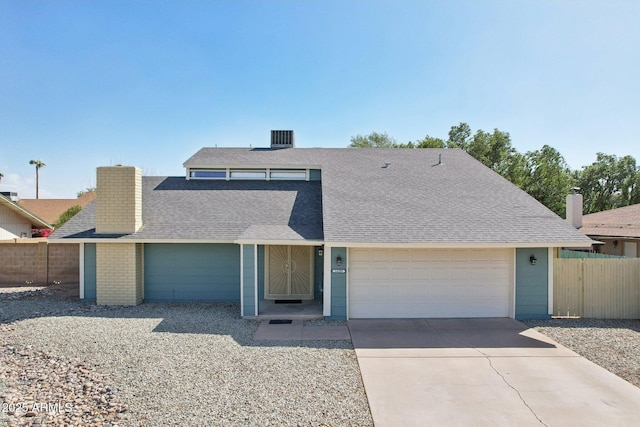 view of front of property with a garage, a shingled roof, driveway, and fence