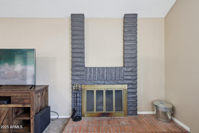 room details with baseboards, a textured ceiling, and a fireplace