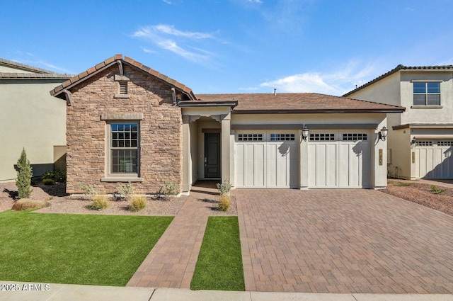 view of front of property with a front lawn and a garage