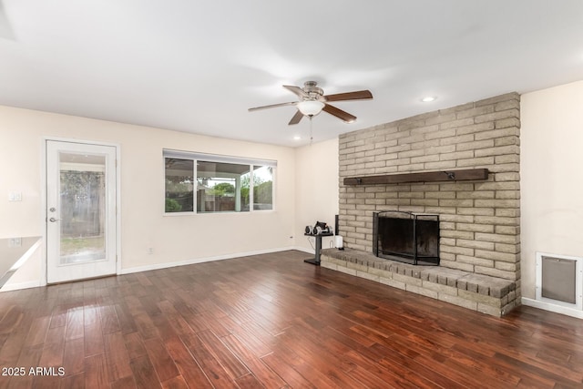 unfurnished living room featuring a ceiling fan, recessed lighting, baseboards, a brick fireplace, and wood finished floors