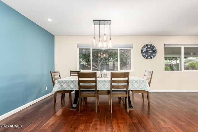 dining space featuring baseboards, a notable chandelier, recessed lighting, and wood finished floors