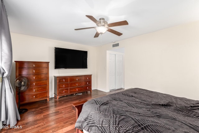 bedroom featuring a ceiling fan, a closet, visible vents, and wood finished floors