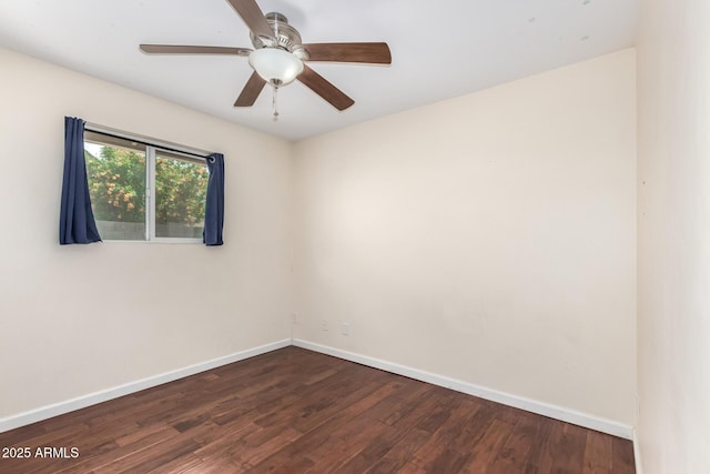unfurnished room with baseboards, a ceiling fan, and dark wood-type flooring