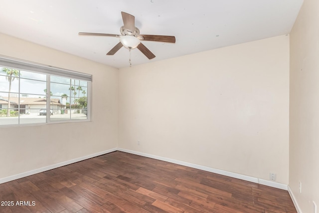 spare room featuring baseboards, a ceiling fan, and hardwood / wood-style floors