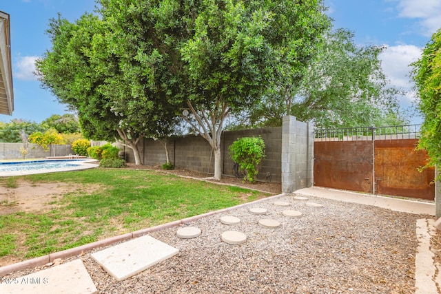 view of yard featuring a fenced in pool and a fenced backyard