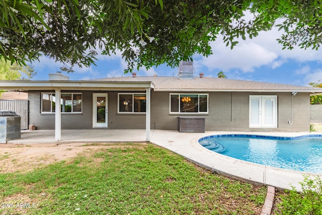 back of house with a lawn, french doors, an outdoor pool, a patio area, and central AC unit