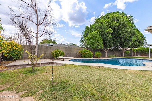 view of pool featuring a fenced backyard, a deck, a fenced in pool, and a yard