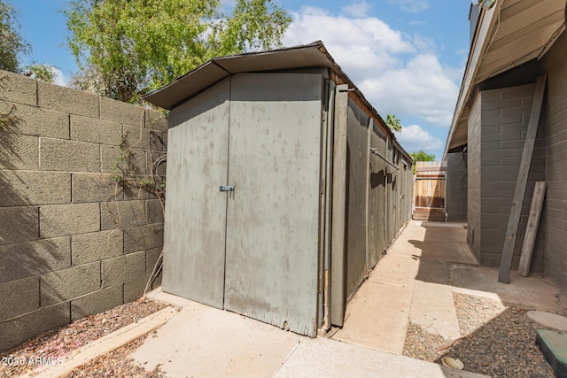 view of shed with fence